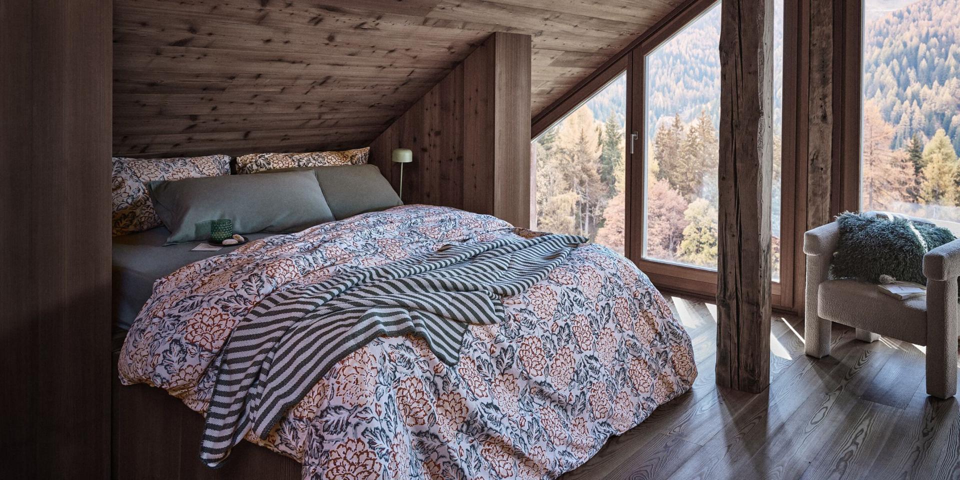 A Coincasa bedroom with layered printed bedding